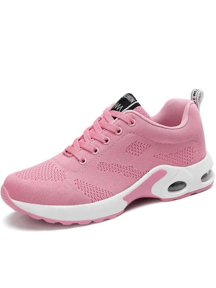 Pink breathable women's running shoes with mesh upper, lace-up closure, and cushioned insole, designed for flexibility and comfort.